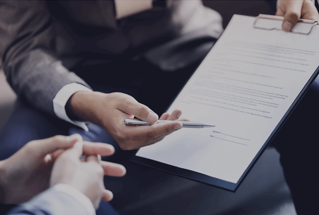 A consultant reviewing application paperwork with a student
